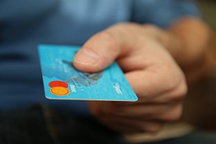 Man’s hand holding debit card